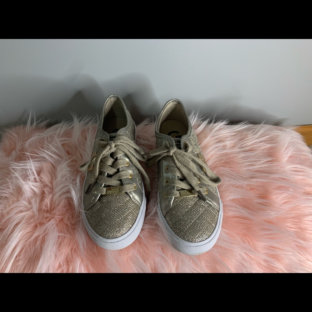 The brand is Guess. They are sparkly sliver with gold accent pieces.